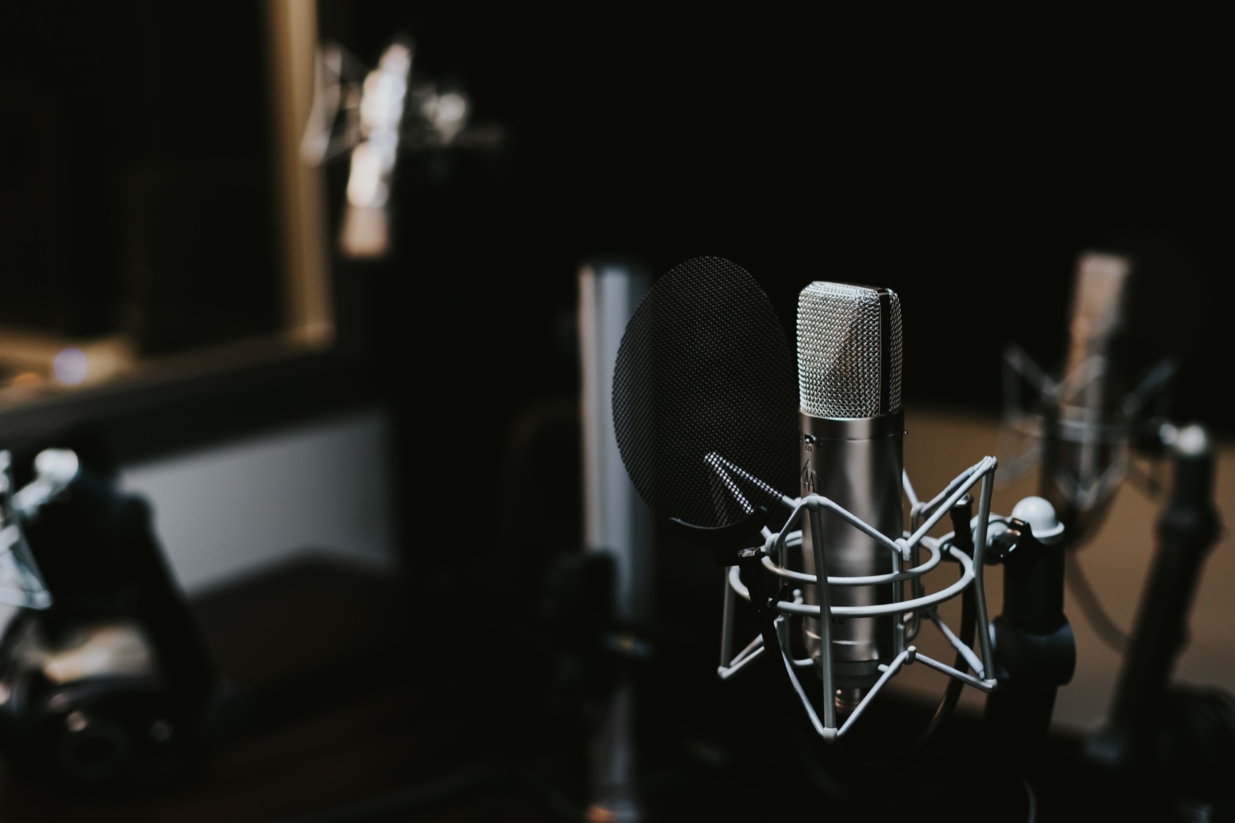 Studio condenser microphone in a dark recording booth