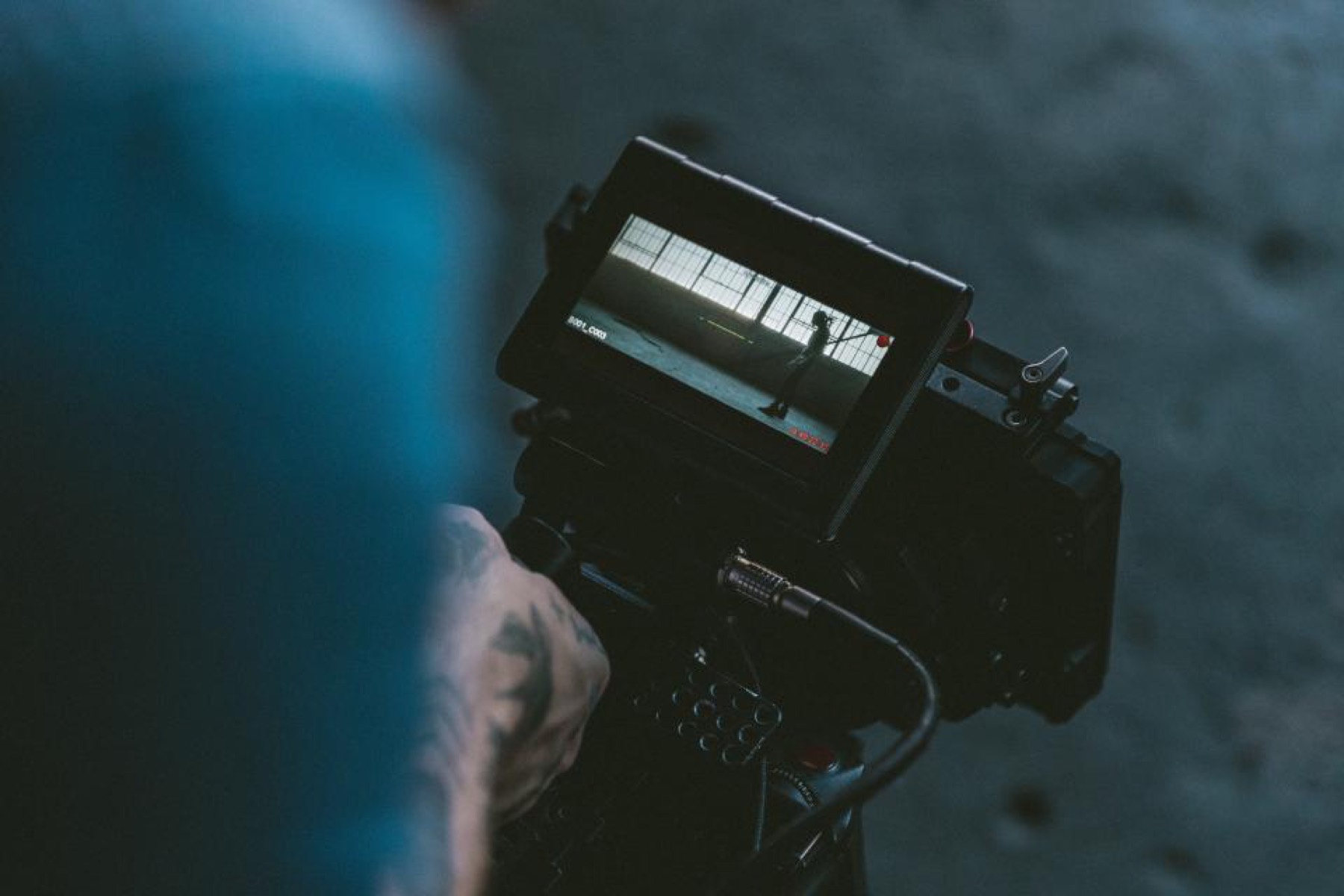 Cinema camera held by a camera operator in low light