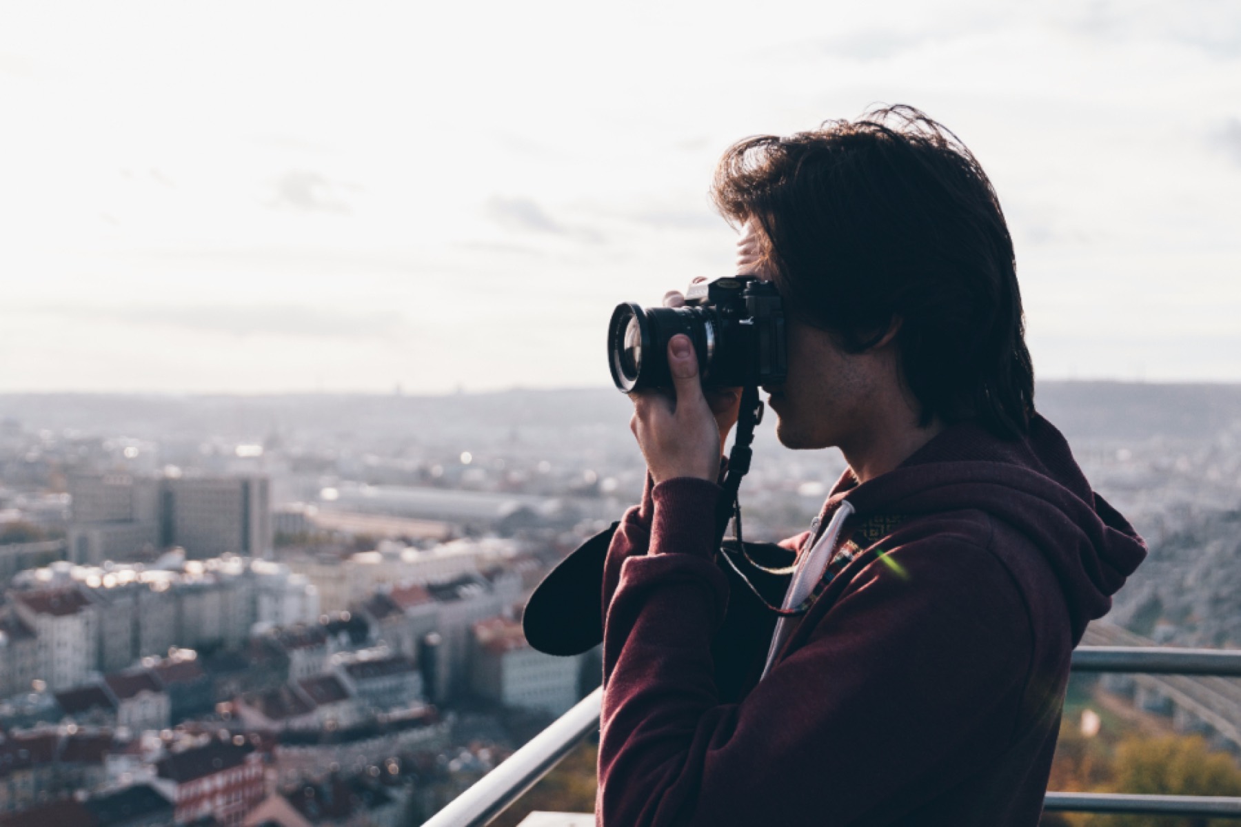 Photographer taking a picture over a city skyline